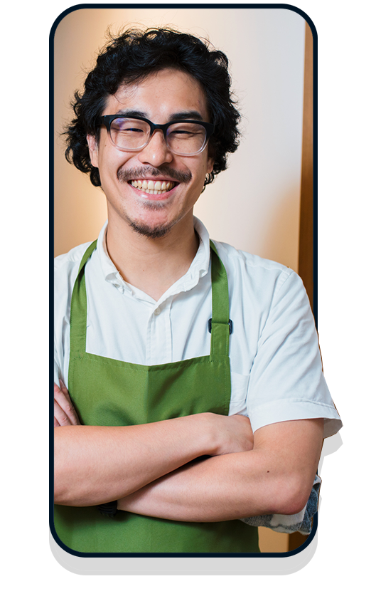 Business owner in white shirt and green apron in mobile frame